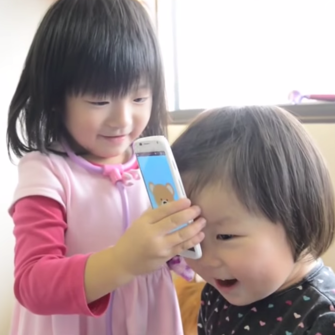 Two Asian children using the application